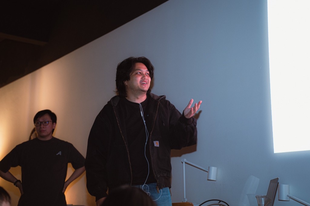 Mid-gesture under the projector light